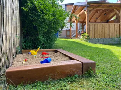 a sandbox in a yard with a toy in it at Penzion Mořina in Mořina