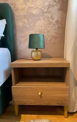 a lamp on a wooden night stand next to a bed at Centrum Prague - Aloha Apartment in Prague
