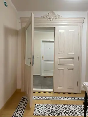 a hallway with a white door and a tile floor at Centrum Prague - Aloha Apartment in Prague