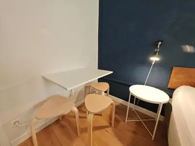 a room with two chairs and a desk and a bed at Flat in Zizkov -101- in Prague