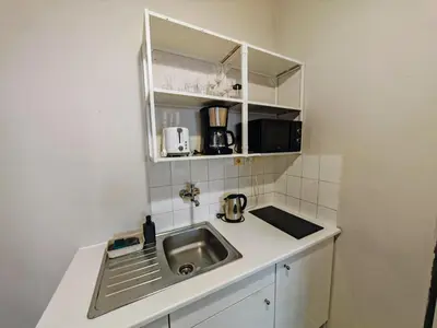 a small kitchen with a sink and a microwave at Flat in Zizkov -101- in Prague