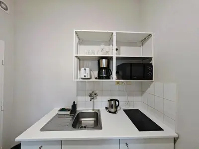 a kitchen with a sink and a microwave at Flat in Zizkov -101- in Prague
