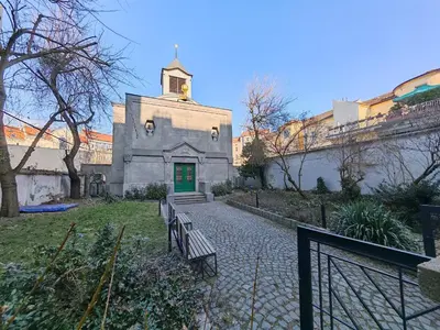 an old building with a green door and benches at Flat in Zizkov -102- in Prague