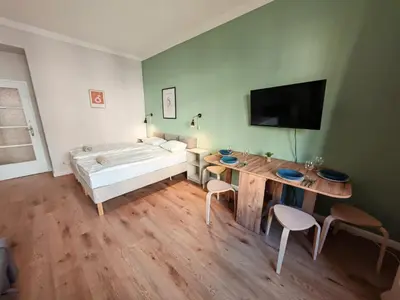 a room with a bed and a table and chairs at Flat in Zizkov -102- in Prague