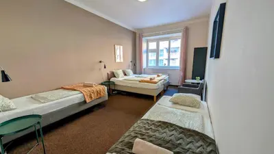 a room with two beds and a window at Flat in Zizkov -103- in Prague