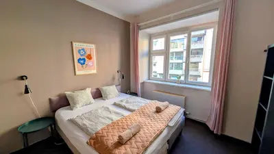 a small bedroom with a bed and a window at Flat in Zizkov -103- in Prague