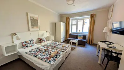 a hotel room with a bed and a desk at Flat in Zizkov -104- in Prague