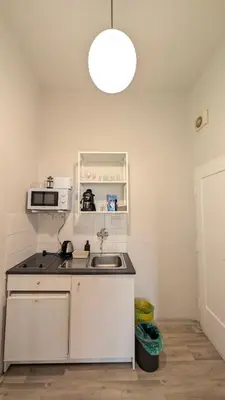 a kitchen with a sink and a microwave at Flat in Zizkov -104- in Prague