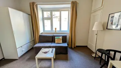 a living room with a couch and a table at Flat in Zizkov -104- in Prague