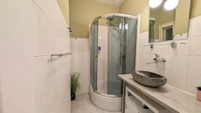 a bathroom with a sink and a shower at Flat in Zizkov -104- in Prague