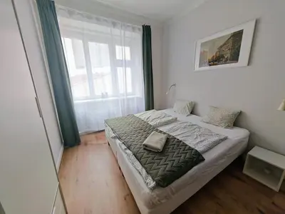 a bed in a room with a large window at Apartment in Zizkov -201- in Prague