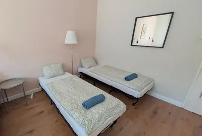 two beds in a room with a mirror and a table at Apartment in Zizkov -201- in Prague