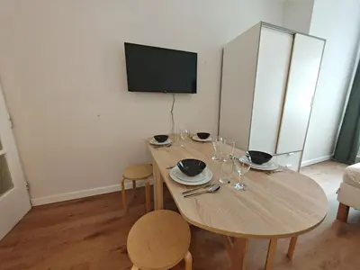 a dining room with a table and chairs and a television at Apartment in Zizkov -201- in Prague