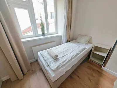 a small bed in a room with a window at Apartment in Zizkov -201- in Prague