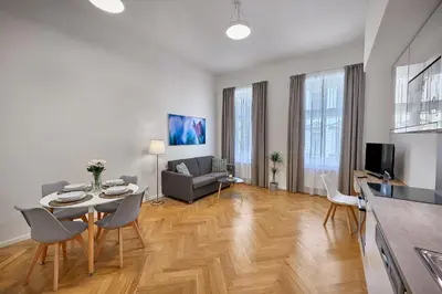 a living room with a table and chairs and a couch at DownTown Suites Rubesova in Prague
