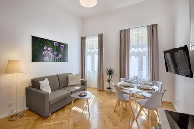 a living room with a couch and a table at DownTown Suites Rubesova in Prague