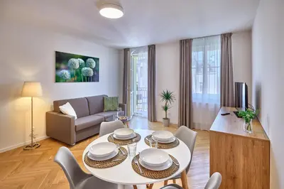 a living room with a white table and chairs at DownTown Suites Rubesova in Prague
