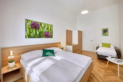 a bedroom with a large bed in a room at DownTown Suites Rubesova in Prague