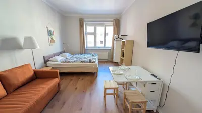 a small living room with a couch and a table at Apartment in Zizkov -202- in Prague