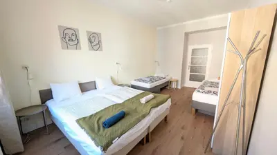 a bedroom with a large bed and two beds sidx sidx sidx at Apartment in Zizkov -202- in Prague