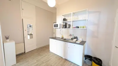 a kitchen with white cabinets and a sink at Apartment in Zizkov -202- in Prague