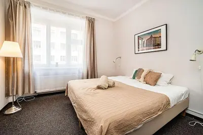a bedroom with a bed and a large window at Apartment in Zizkov -203- in Prague
