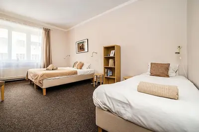 a hotel room with two beds and a window at Apartment in Zizkov -203- in Prague