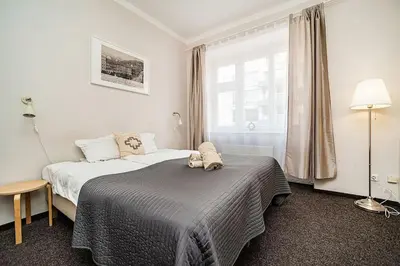 a hotel room with two beds and a window at Apartment in Zizkov -203- in Prague