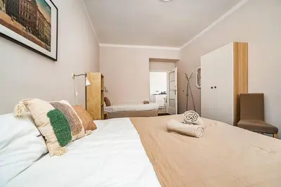 a white bed with pillows on it in a room at Apartment in Zizkov -203- in Prague