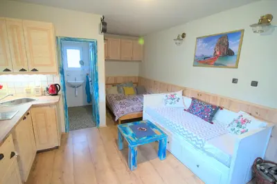 a room with a couch and a sink in a kitchen at Bouda Berounka in Lety