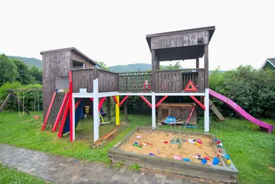 a play area with a playground with a play house at Bouda Berounka in Lety