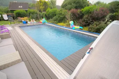 a swimming pool with a toy in a backyard at Bouda Berounka in Lety