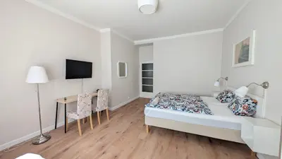 a bedroom with a bed and a table with chairs at Flat in Zizkov -204- in Prague