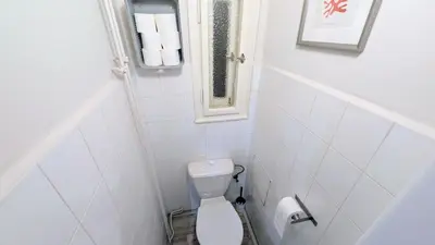 a small bathroom with a toilet and a window at Flat in Zizkov -204- in Prague