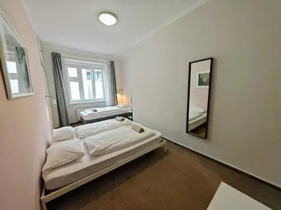 a room with a bed and a mirror in it at Apartment in Zizkov -301- in Prague