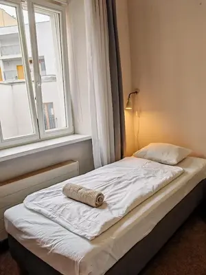 a bed in a room with a window at Apartment in Zizkov -301- in Prague