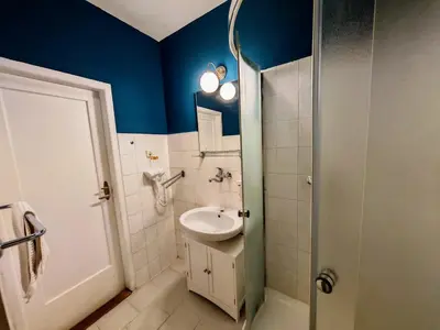 a bathroom with a sink and a toilet and blue walls at Apartment in Zizkov -301- in Prague