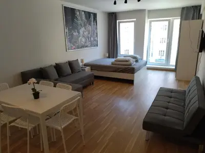 a living room with a couch and a table at Brand new two room apartment #34 with free secure parking in the center in Prague