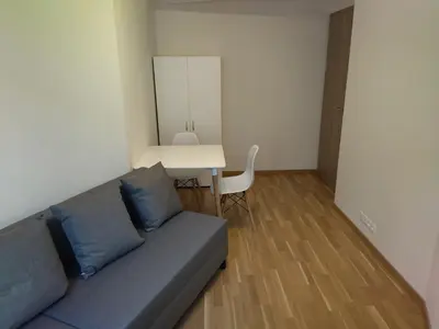 a living room with a couch and a table at Brand new two room apartment #34 with free secure parking in the center in Prague
