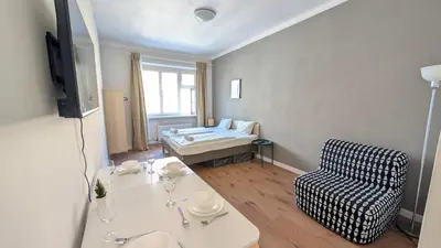a room with a table and a chair and a bed at Flat in Zizkov -302- in Prague