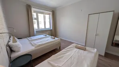 a bedroom with a bed and a chair and a window at Flat in Zizkov -302- in Prague