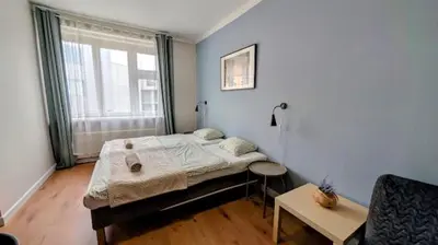 a small bedroom with a bed and a window at Flat in Zizkov with free underground parking -501- in Prague