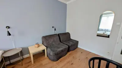 a living room with a couch and a table at Flat in Zizkov with free underground parking -501- in Prague