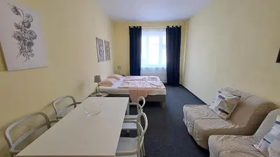 a living room with two beds and a couch at Flat in Zizkov -402- in Prague