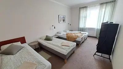 a living room with three beds and a couch at Flat in Zizkov -402- in Prague