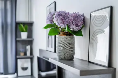 a vase filled with purple flowers sitting on a table at Rentero Wenceslas square Apartment, Prague in Prague