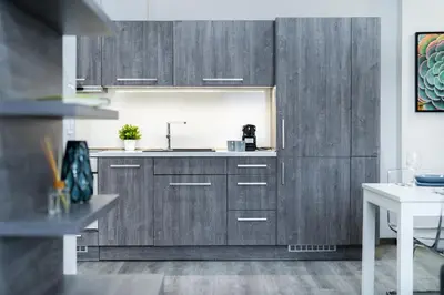 a kitchen with wooden cabinets and a sink at Rentero Wenceslas square Apartment, Prague in Prague