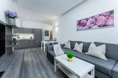a living room with a couch and a table at Rentero Wenceslas square Apartment, Prague in Prague