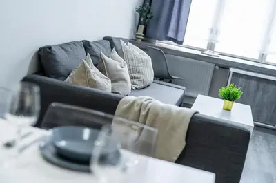 a living room with a couch and a table at Rentero Wenceslas square Apartment, Prague in Prague