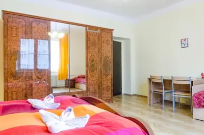 a bedroom with a large red bed with white pillows at Rooms in the Center of Old Town in Prague